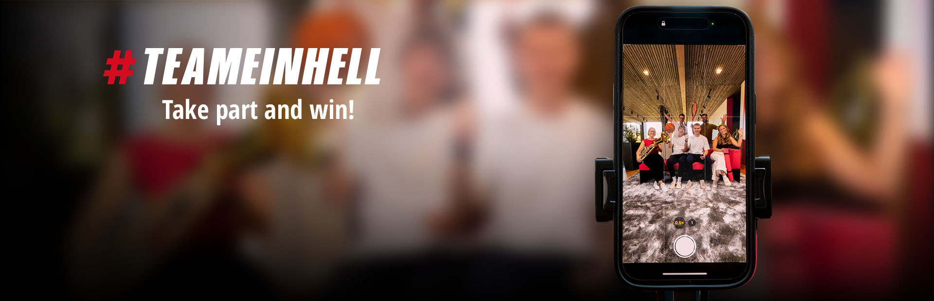 A smartphone shows a group photo of six people with sports equipment and instruments. On the left: "#TEAMEINHELL Take part and win!"