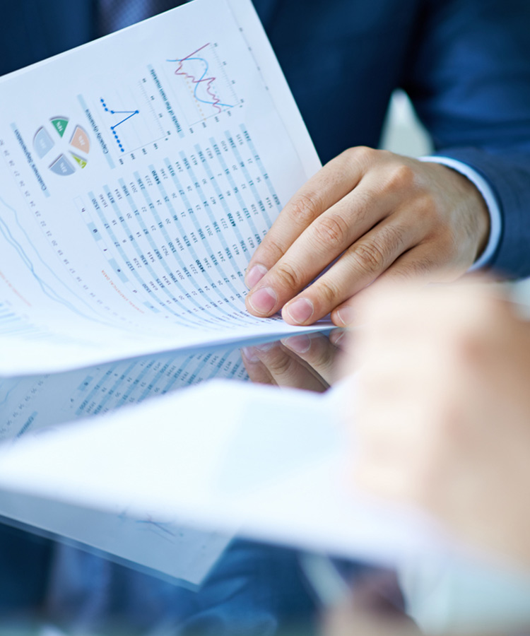 Photo of a person that looks at a financial report.