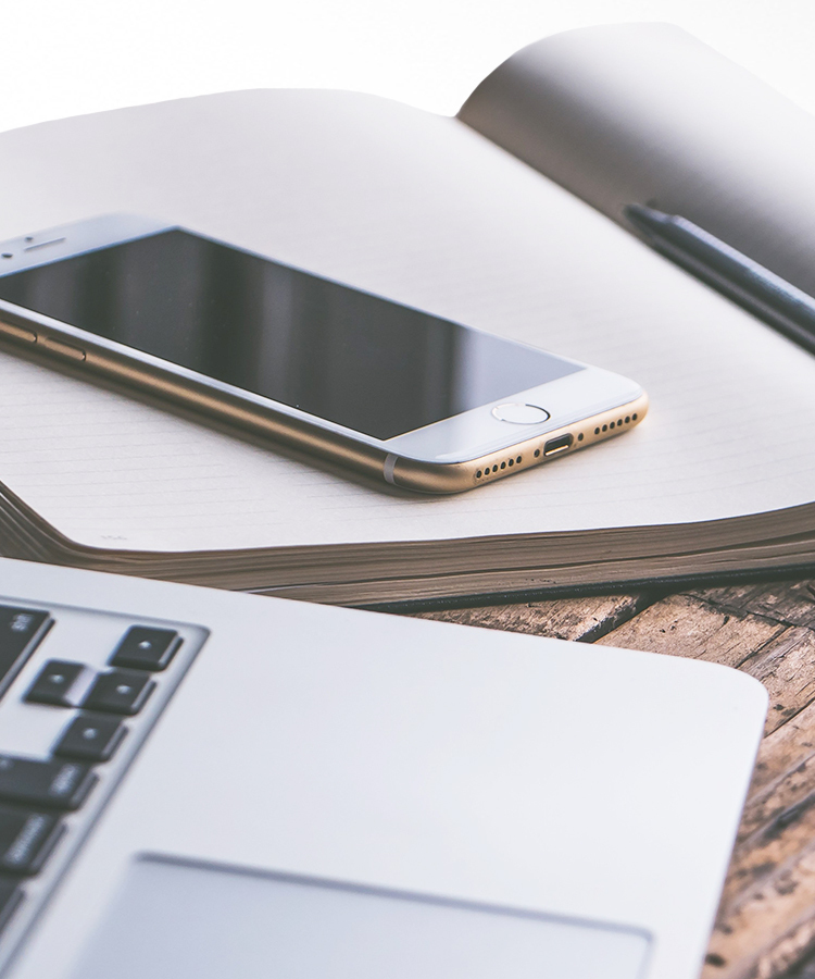 Picture of a smartphone on a notebook.